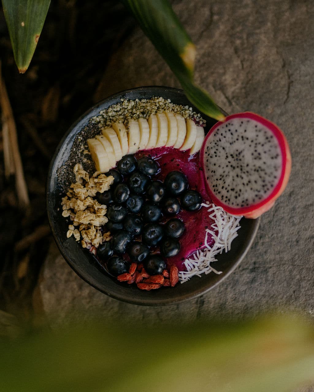 Açaí bowl in tropical leaves
